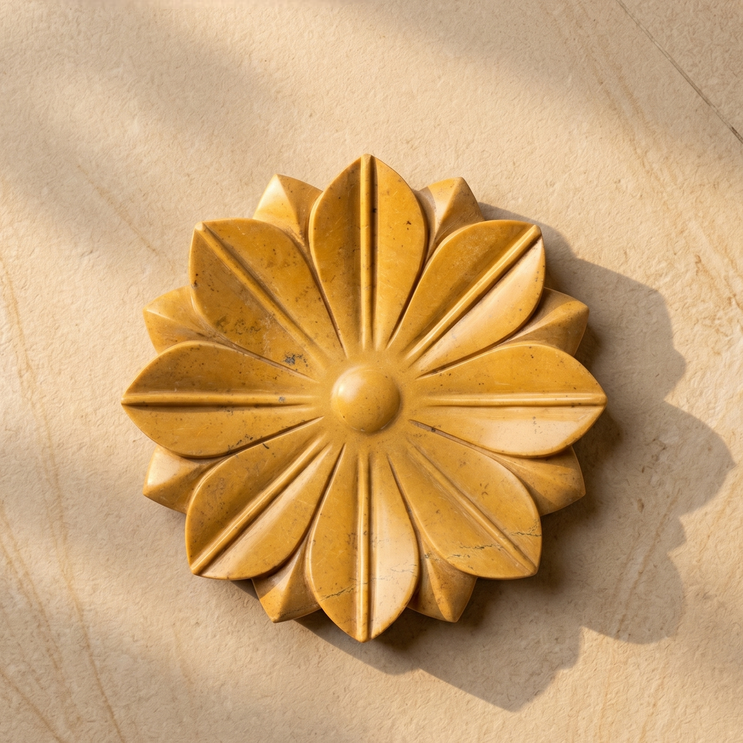 Decorative wooden flower pattern on a Jaisalmer yellow stone surface